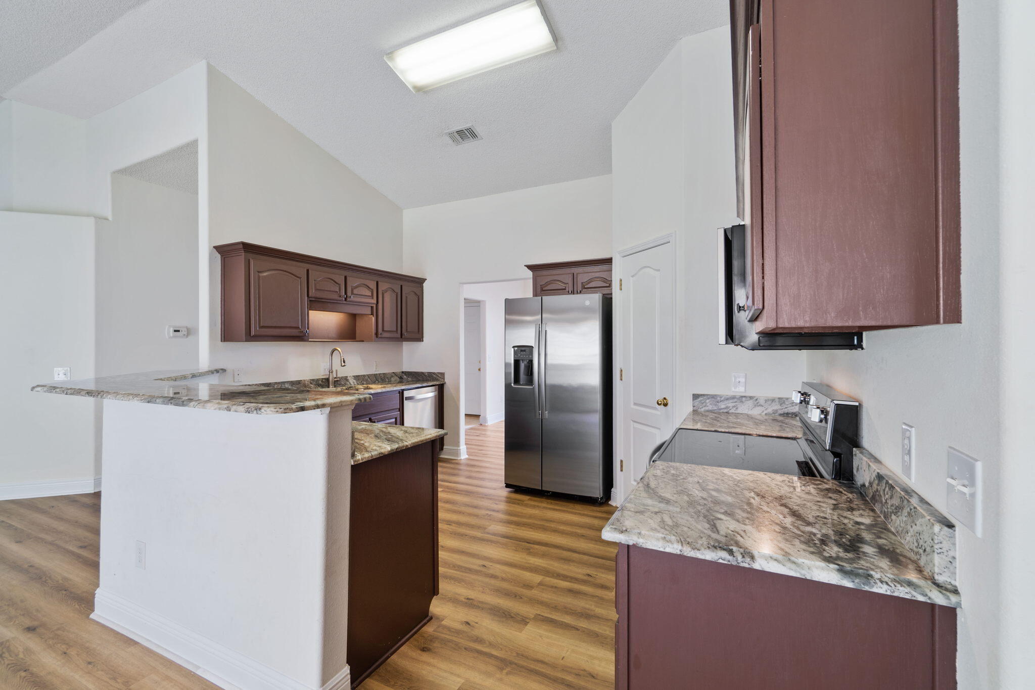 641 Territory Lane Crestview, FL 32536 - Photo 14 of 41 a kitchen with stainless steel appliances granite countertop a sink stove and refrigerator