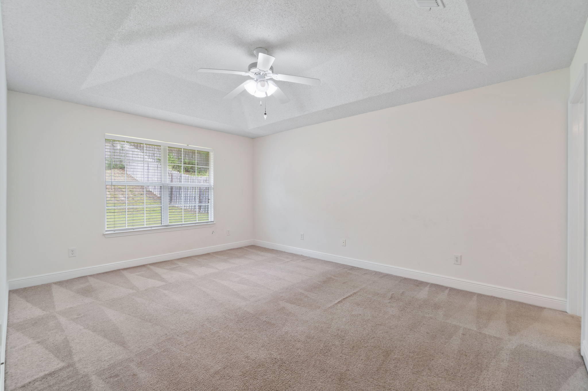 641 Territory Lane Crestview, FL 32536 - Photo 21 of 41 an empty room with windows and fan