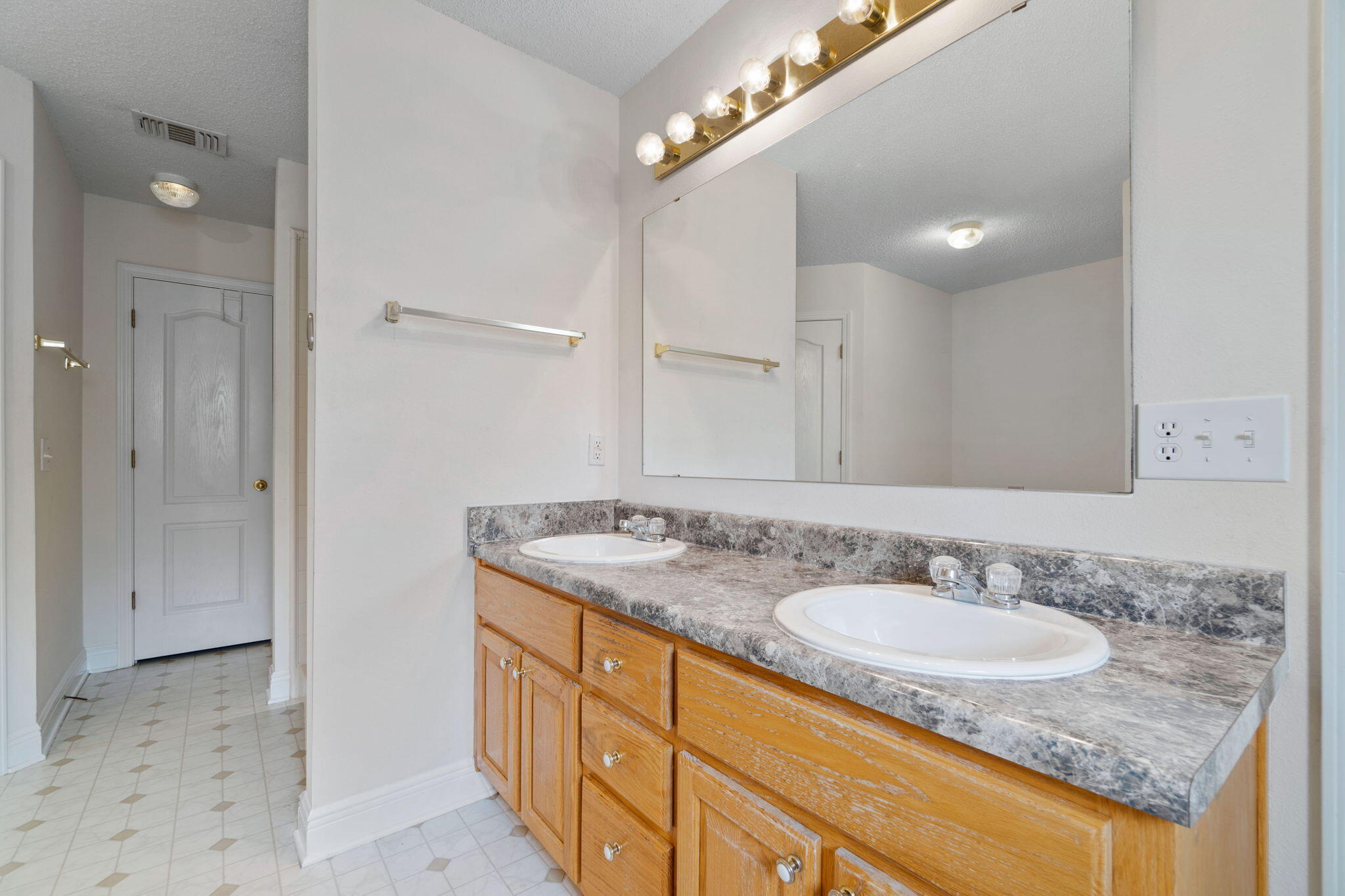 641 Territory Lane Crestview, FL 32536 - Photo 24 of 41 a bathroom with a granite countertop sink and a mirror