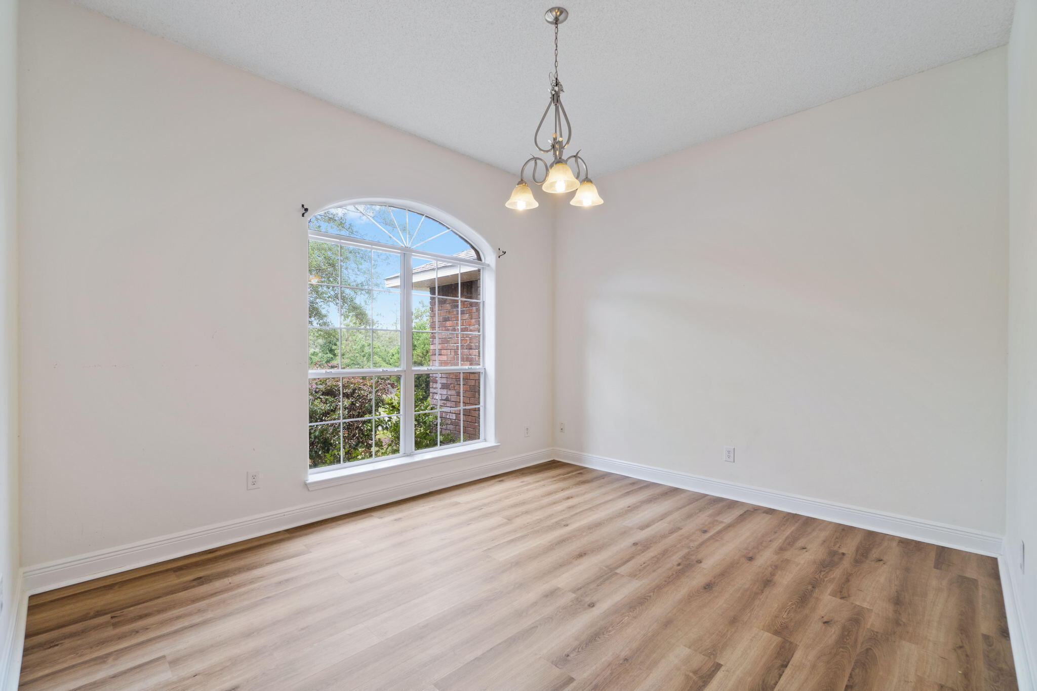 641 Territory Lane Crestview, FL 32536 - Photo 7 of 41 a view of an empty room with wooden floor and a window