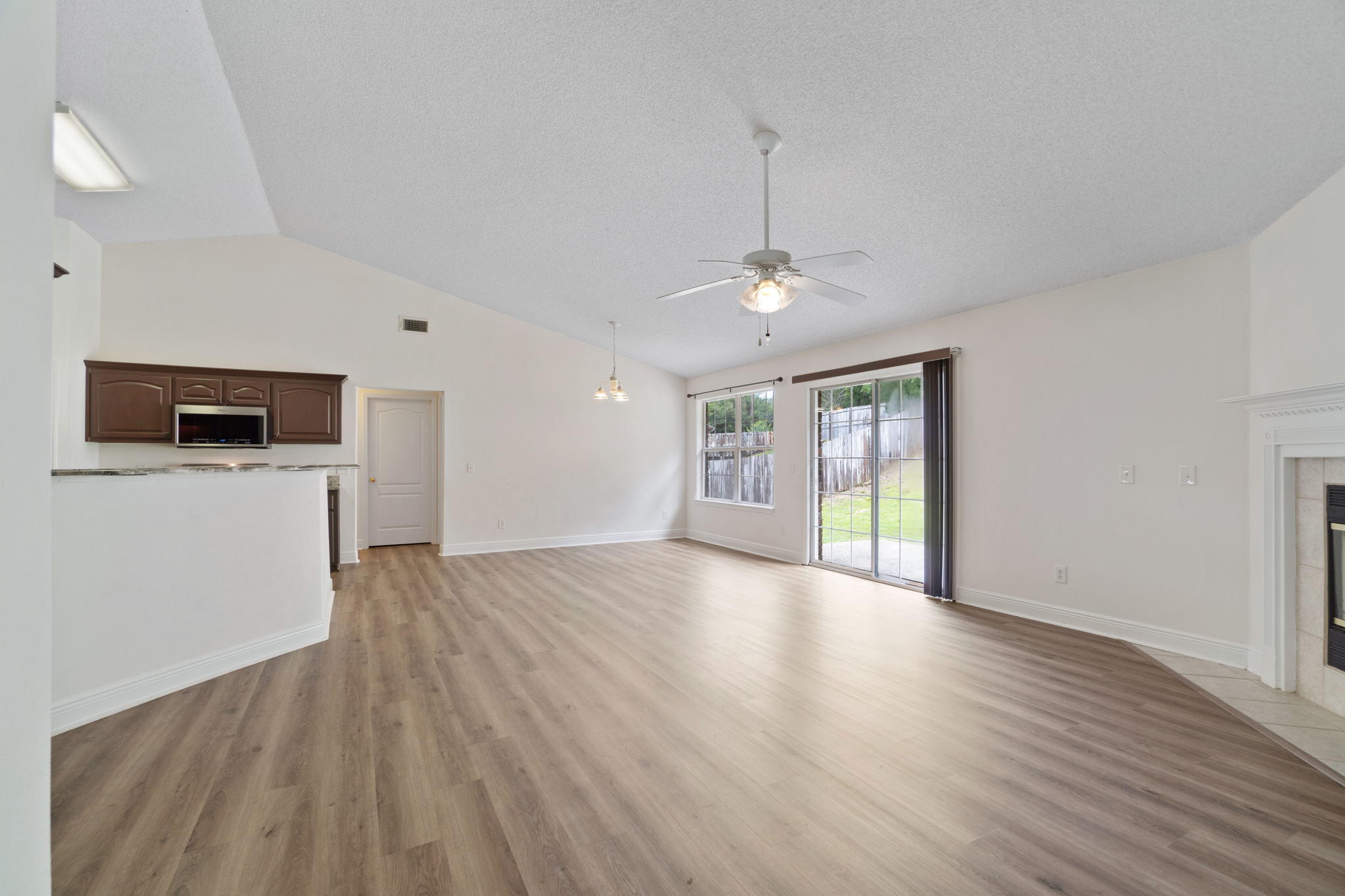 641 Territory Lane Crestview, FL 32536 - Photo 8 of 41 a view of an empty room with wooden floor and a window
