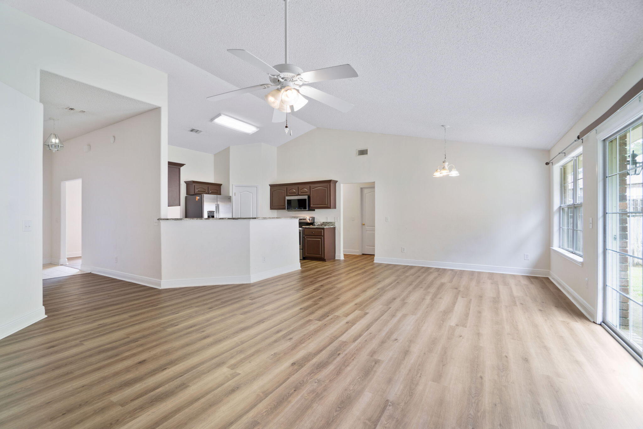 641 Territory Lane Crestview, FL 32536 - Photo 9 of 41 a view of a kitchen with a sink oven window and wooden floor