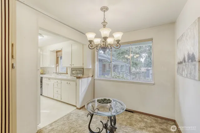 a dining room with wooden floor chandelier