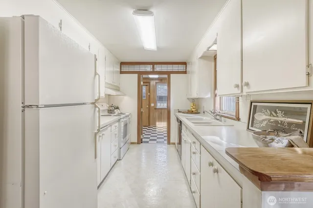 a bathroom with a granite countertop sink a mirror and a shower