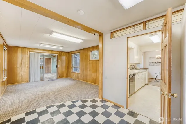a living room with a large window and a chandelier