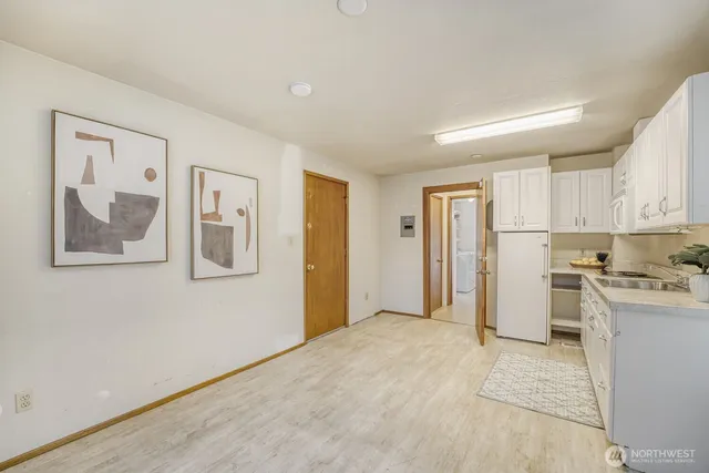 a view of a kitchen with a refrigerator cabinets and a window