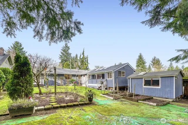 a front view of house with yard swimming pool and outdoor seating