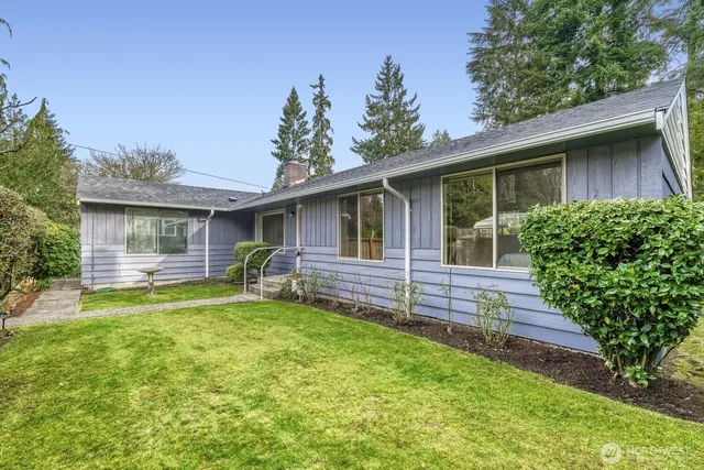 a view of house with a backyard