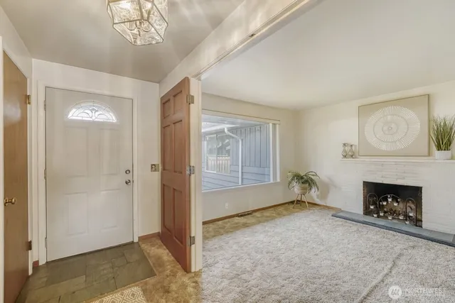 wooden floor fireplace and windows in an empty room