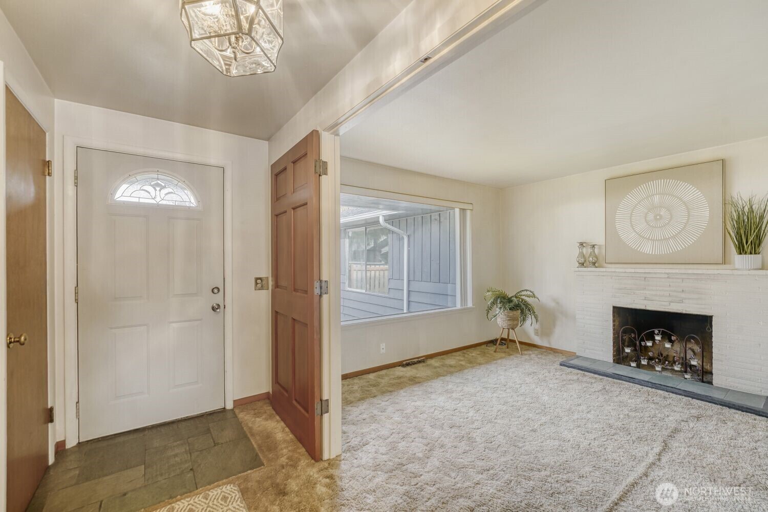 16436 16th Avenue Southwest Burien, WA 98166 - Photo 5 of 30 wooden floor fireplace and windows in an empty room