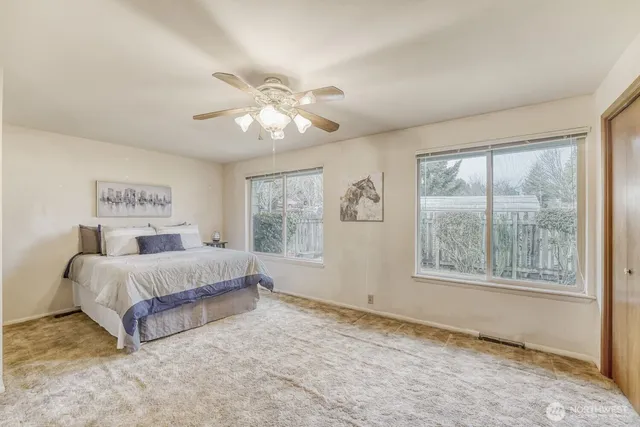 a spacious bedroom with a large bed and a window