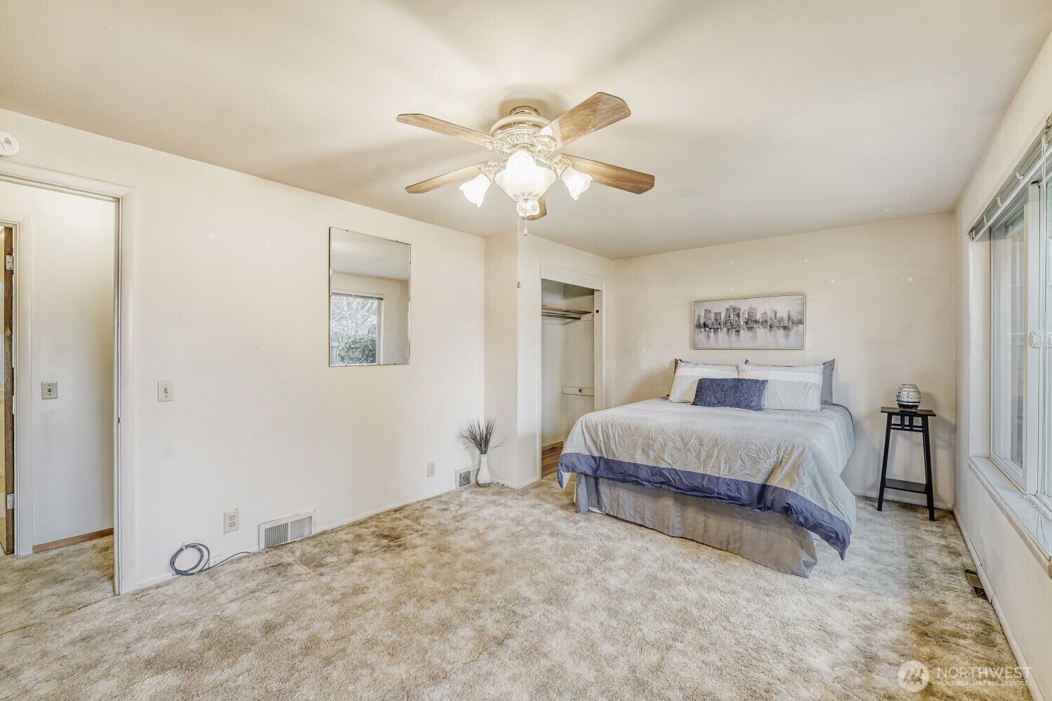 16436 16th Avenue Southwest Burien, WA 98166 - Photo 10 of 30 a spacious bedroom with a bed and a chandelier