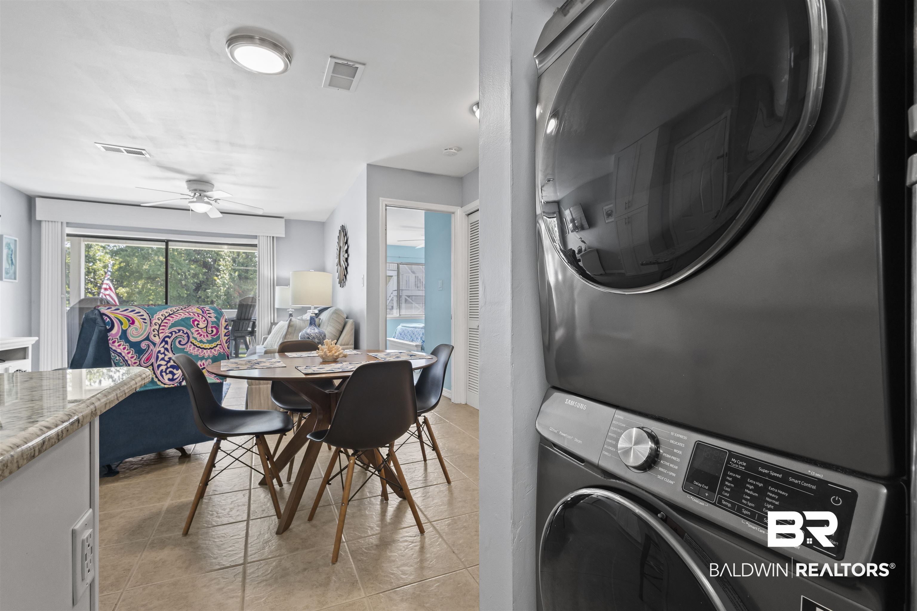 25925 Canal Road, Unit 207 Orange Beach, AL 36561 - Photo 17 of 42 Clothes washing area featuring ceiling fan, stacked washer and dryer, and light tile floors