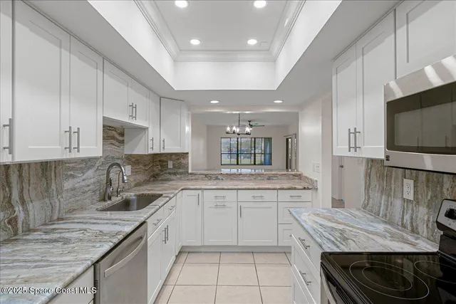 a kitchen with granite countertop a sink and cabinets