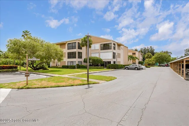a view of house with swimming pool and yard
