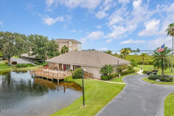 a view of swimming pool with a yard and lake view