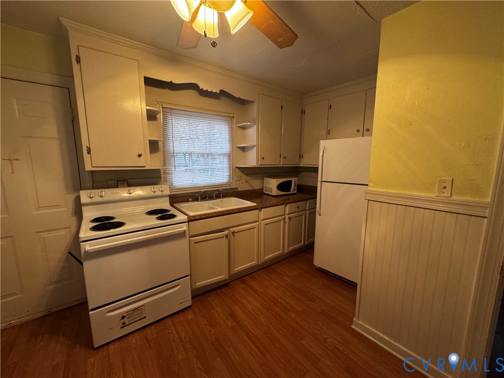 5606 Lakeside Avenue Henrico, VA 23228 - Photo 3 of 10 a kitchen with sink a refrigerator and white cabinets