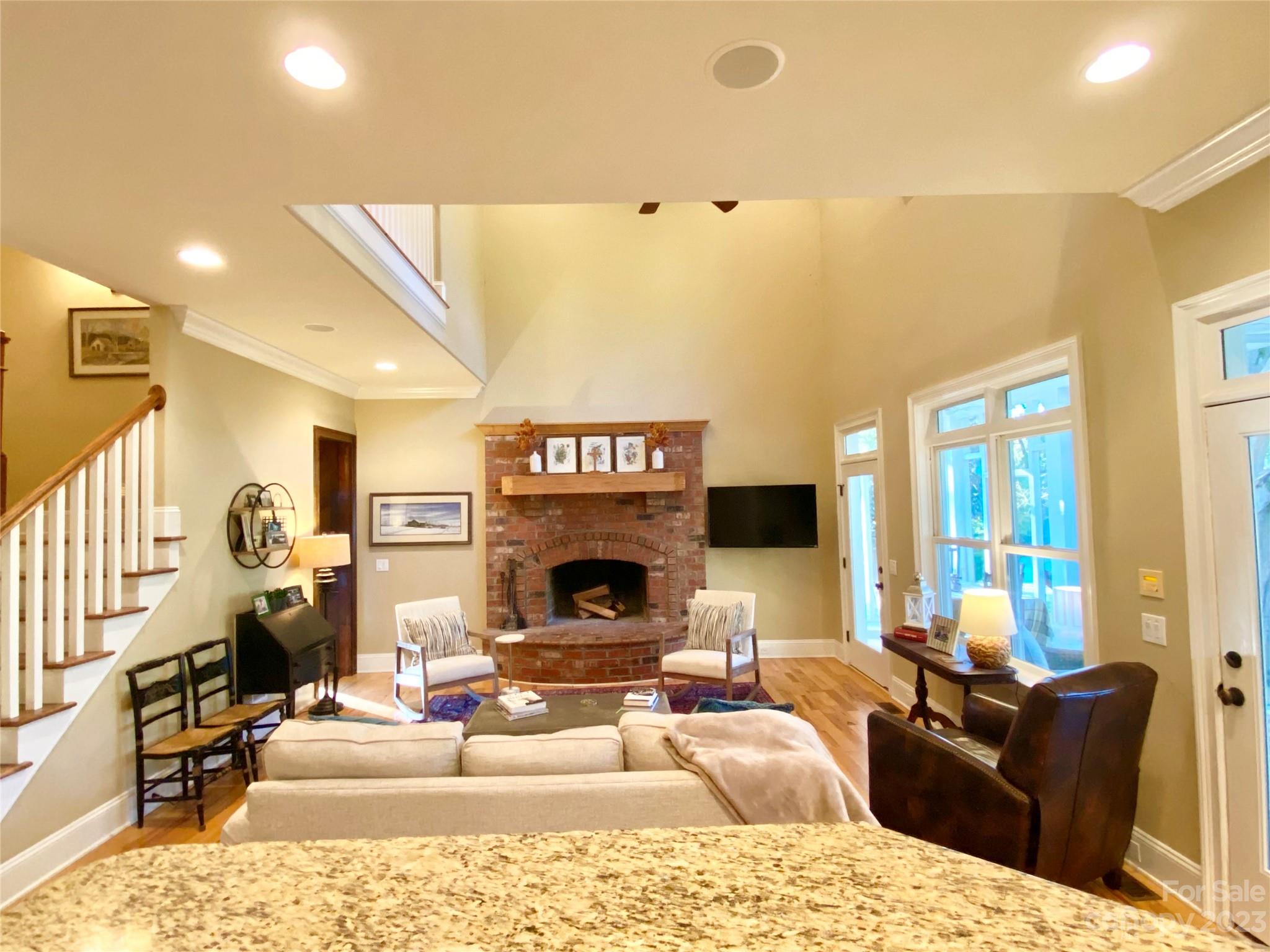 13849 Beatties Ford Road Huntersville, NC 28078 - Photo 15 of 48 a living room with furniture a fireplace and a flat screen tv