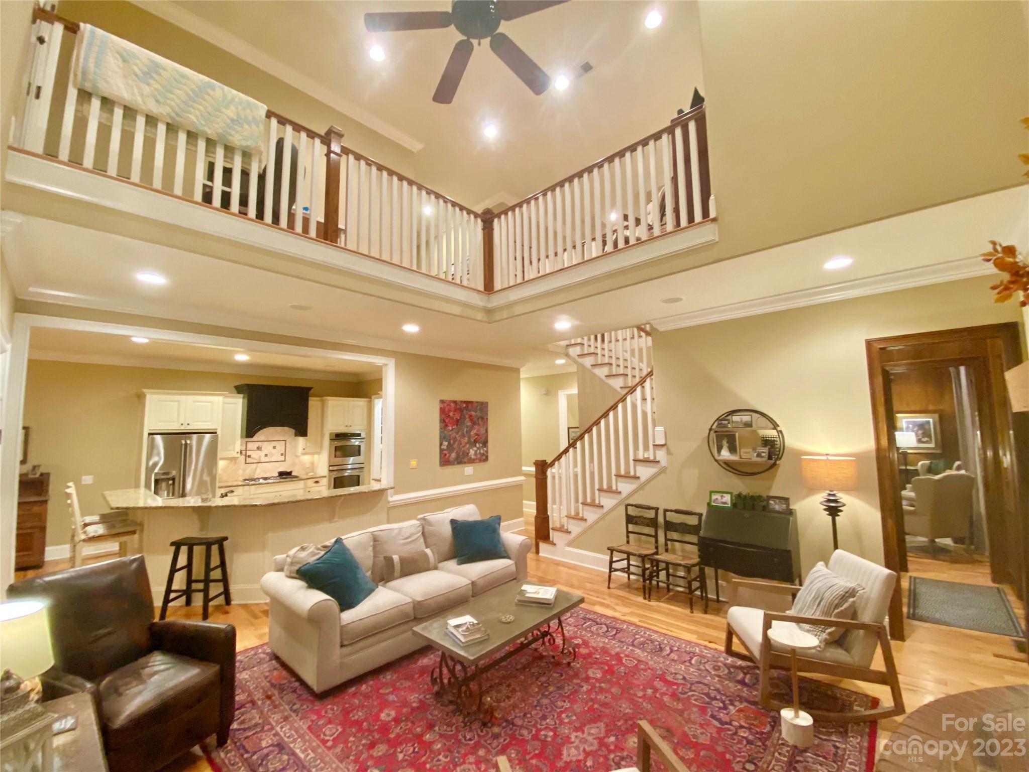 13849 Beatties Ford Road Huntersville, NC 28078 - Photo 18 of 48 a living room with furniture a rug and a clock