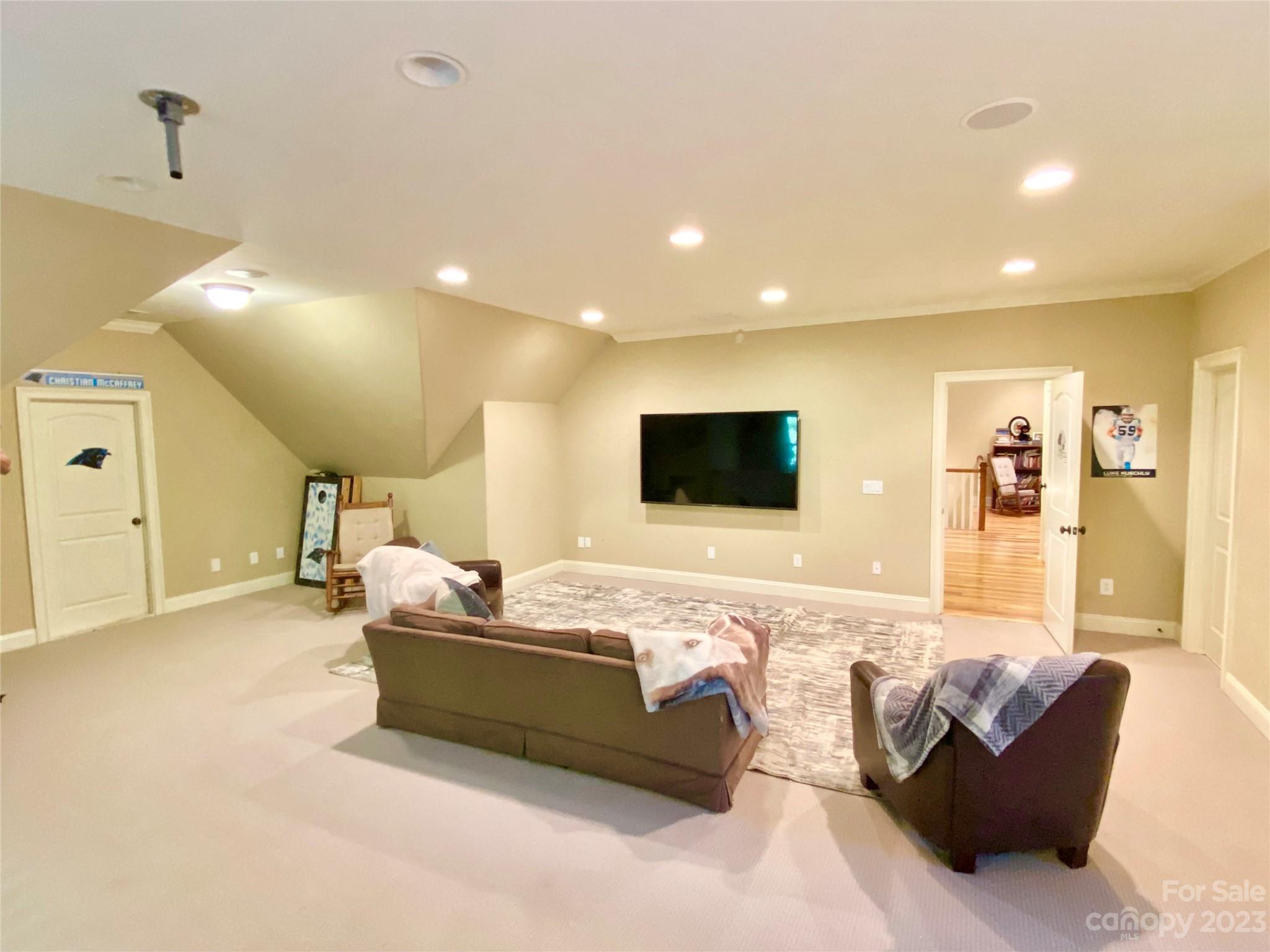 13849 Beatties Ford Road Huntersville, NC 28078 - Photo 33 of 48 a living room with furniture and a flat screen tv