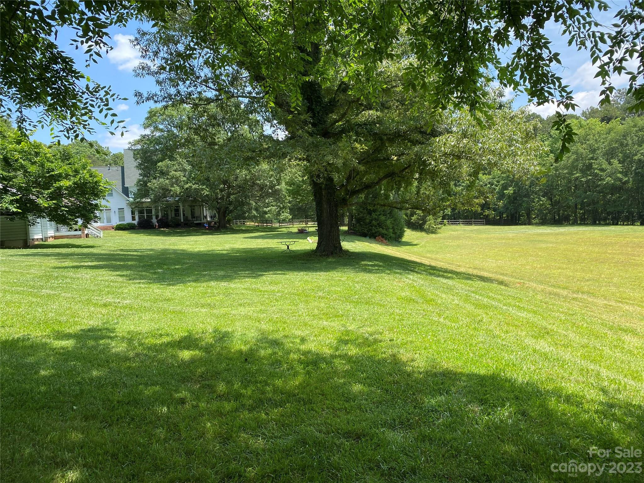 13849 Beatties Ford Road Huntersville, NC 28078 - Photo 43 of 48 a view of a field with an trees