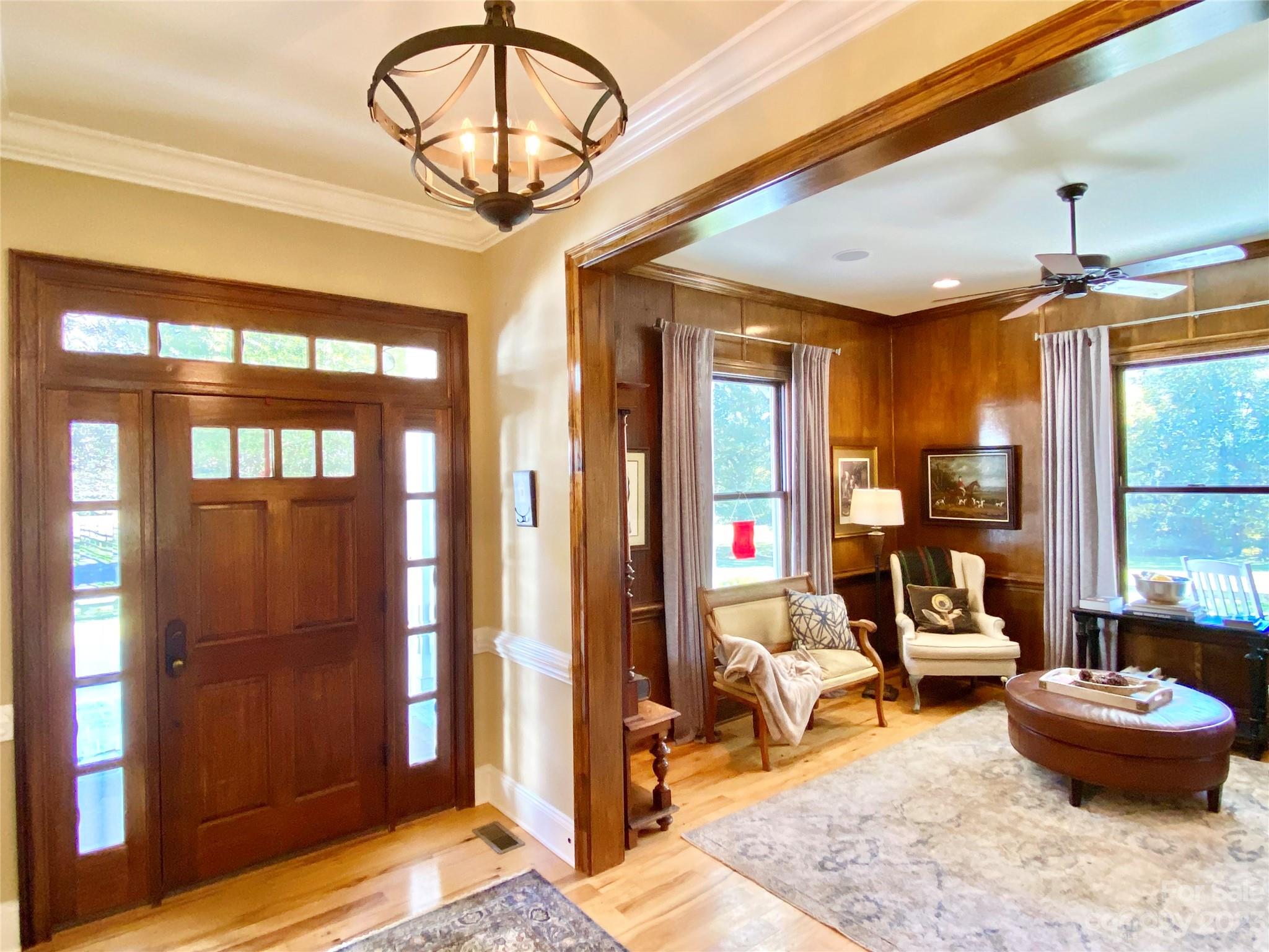 13849 Beatties Ford Road Huntersville, NC 28078 - Photo 8 of 48 a living room with a fireplace and a chandelier