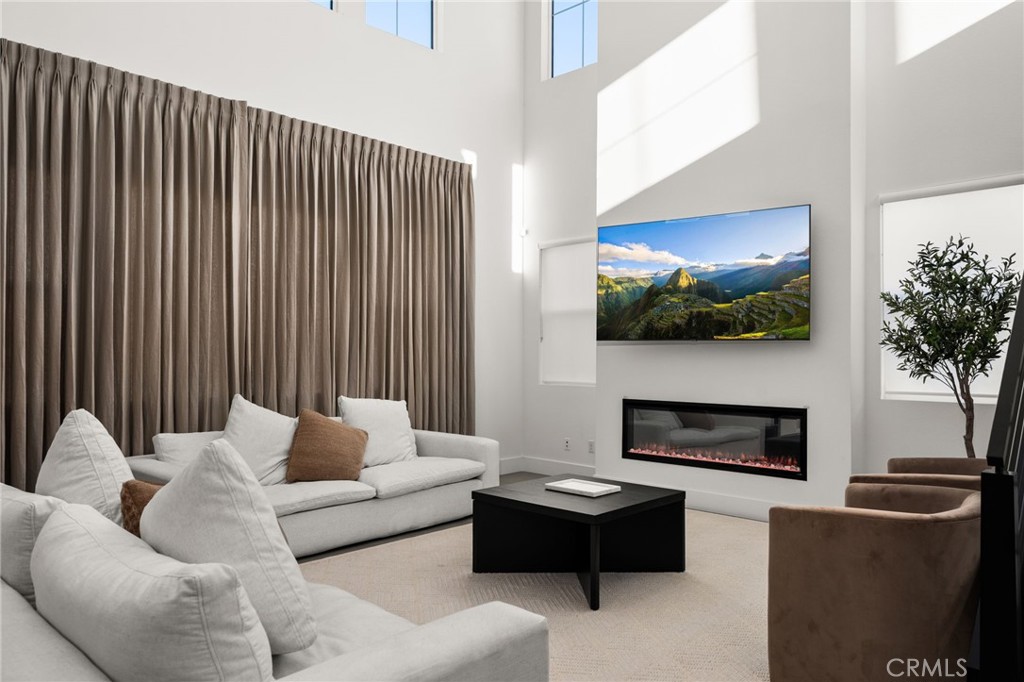 11401 West Serrano Square Yucaipa, CA 92399 - Photo 12 of 46 a living room with furniture a fireplace and a flat screen tv