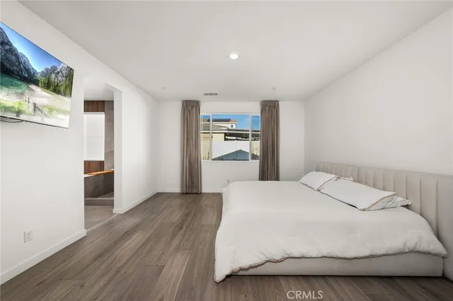 a large white bed in a white room