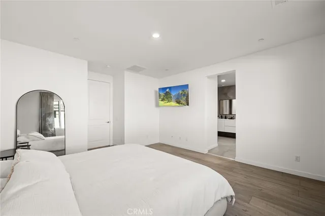 a bedroom with a bed and a dresser