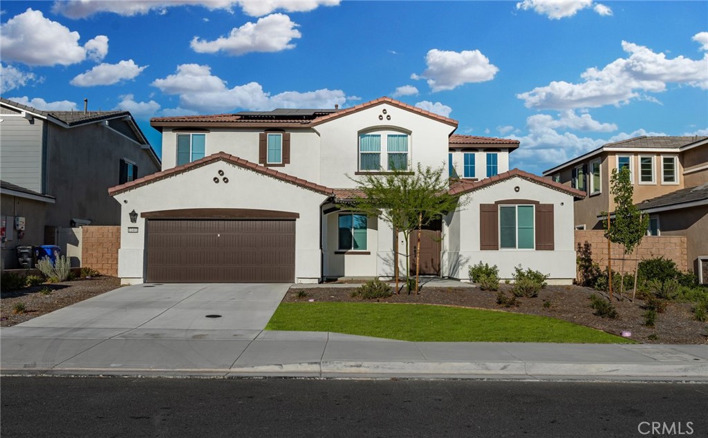 11401 West Serrano Square Yucaipa, CA 92399 - Photo 2 of 46 a front view of a house with a yard and garage
