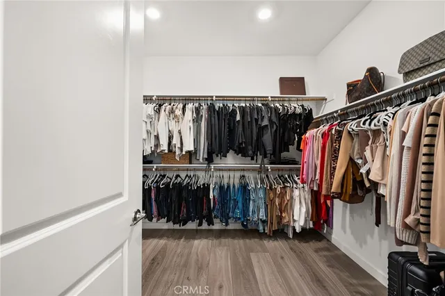 a view of walk in closet with clothes