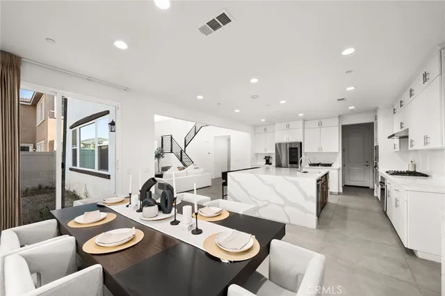 a living room with furniture and kitchen view