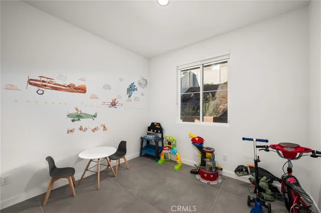 a living room with a bed and a window