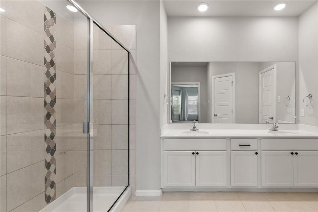 6910 Prairieside Trail Venus, TX 76084 - Photo 22 of 40 Bathroom featuring a spacious shower with tiled walls and an accent mosaic stripe