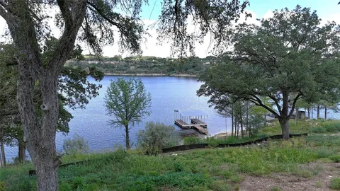 an aerial view of a house with a yard