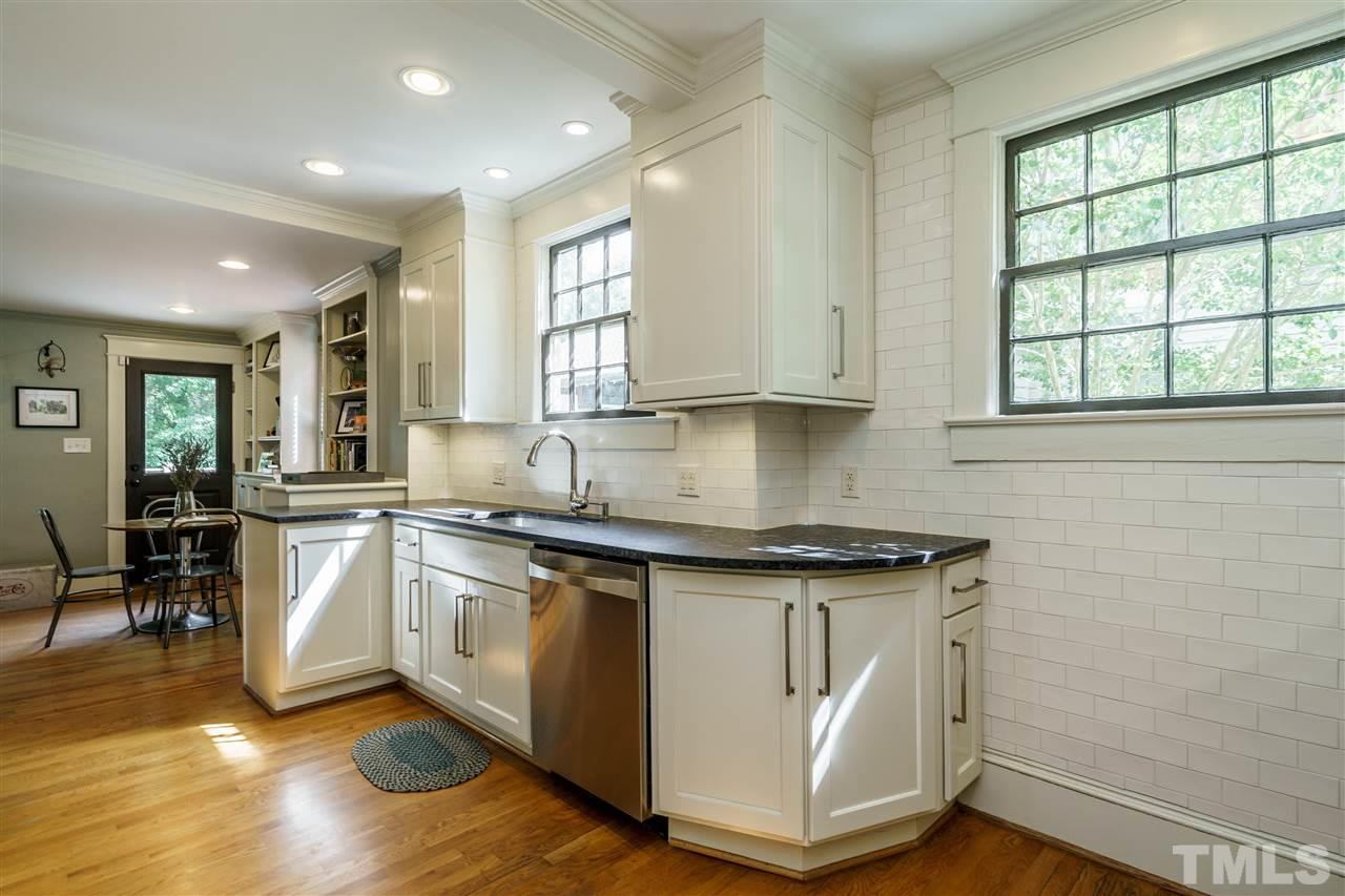 121 Hudson Street Raleigh, NC 27608 - Photo 11 of 30 a kitchen with stainless steel appliances granite countertop a stove a sink and a microwave
