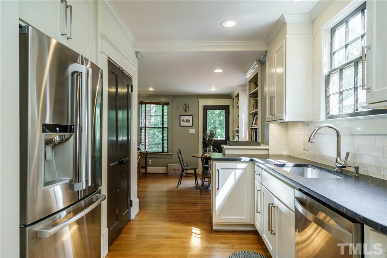121 Hudson Street Raleigh, NC 27608 - Photo 12 of 30 a kitchen with stainless steel appliances granite countertop a refrigerator a sink a stove and white cabinets