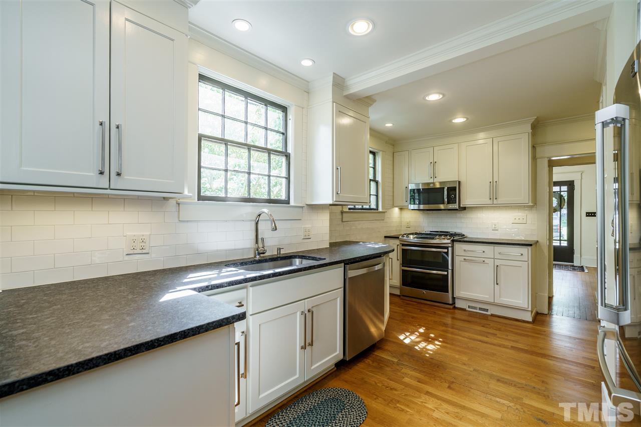121 Hudson Street Raleigh, NC 27608 - Photo 13 of 30 a kitchen with stainless steel appliances granite countertop a sink stove and refrigerator