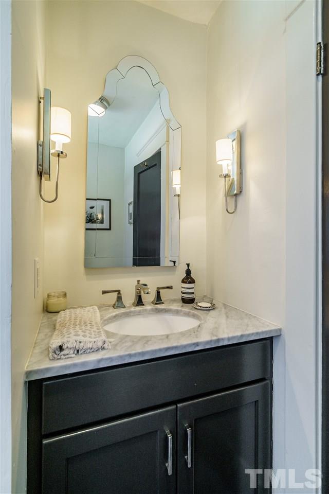 121 Hudson Street Raleigh, NC 27608 - Photo 20 of 30 a bathroom with a sink and a mirror