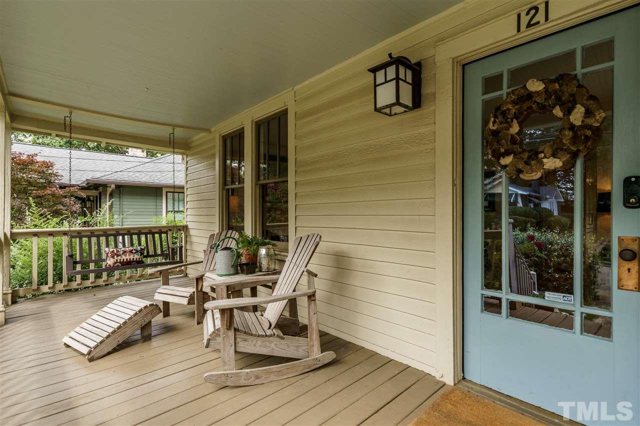 121 Hudson Street Raleigh, NC 27608 - Photo 3 of 30 a view of a chairs and table in a balcony