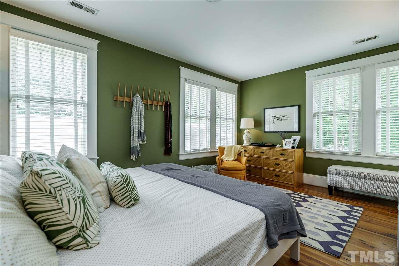 121 Hudson Street Raleigh, NC 27608 - Photo 21 of 30 a bedroom with a bed couch and windows