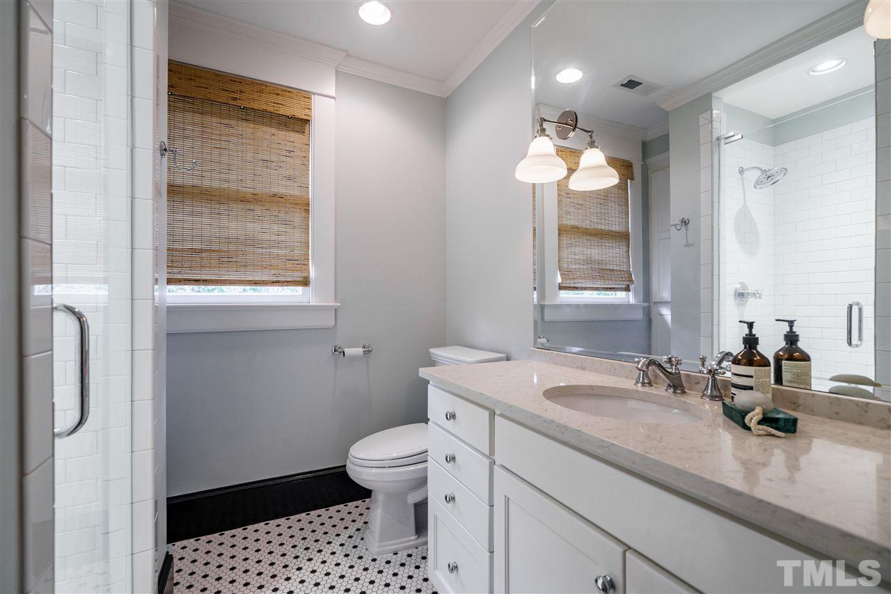 121 Hudson Street Raleigh, NC 27608 - Photo 26 of 30 a bathroom with a sink a toilet and a mirror
