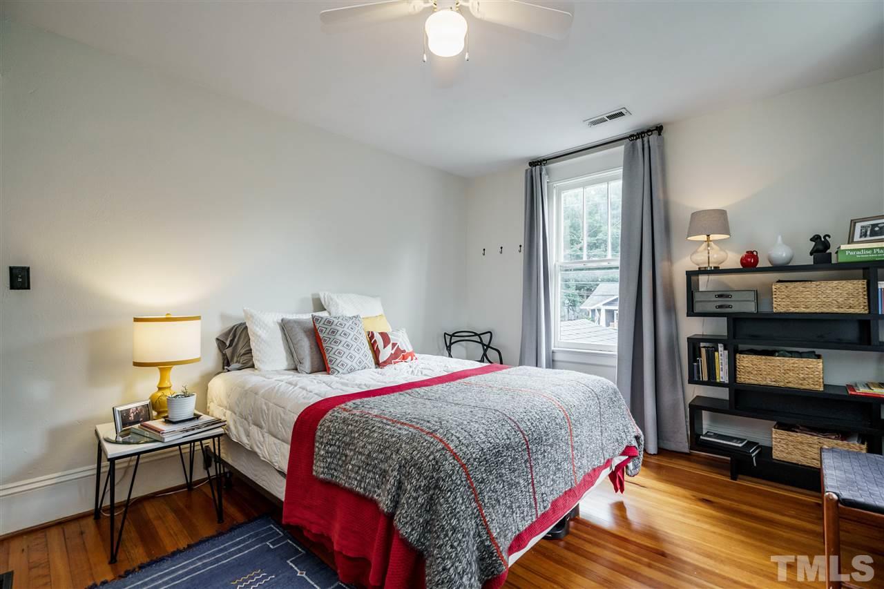 121 Hudson Street Raleigh, NC 27608 - Photo 27 of 30 a bedroom with a bed and a book shelf