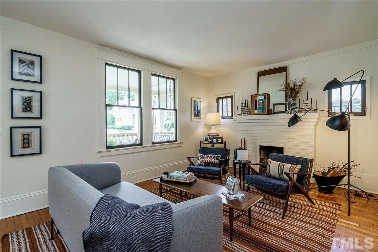 121 Hudson Street Raleigh, NC 27608 - Photo 8 of 30 a living room with furniture a fireplace and a window