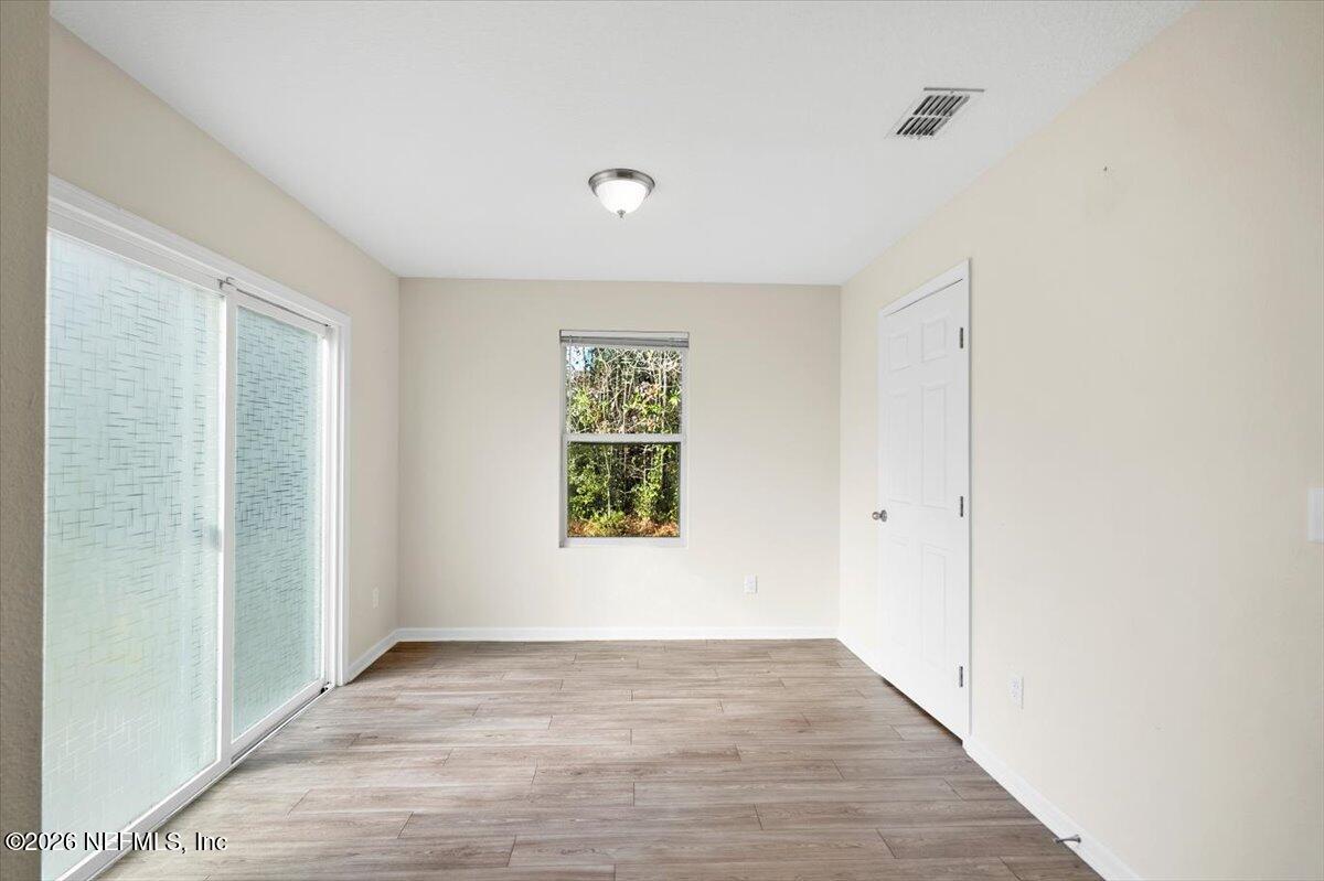3094 Jennings Road Jacksonville, FL 32218 - Photo 11 of 33 a view of an empty room with wooden floor and a window