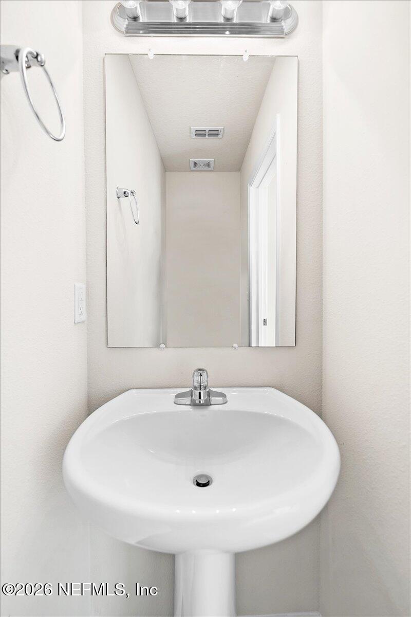 3094 Jennings Road Jacksonville, FL 32218 - Photo 12 of 33 a bathroom with a sink and a mirror