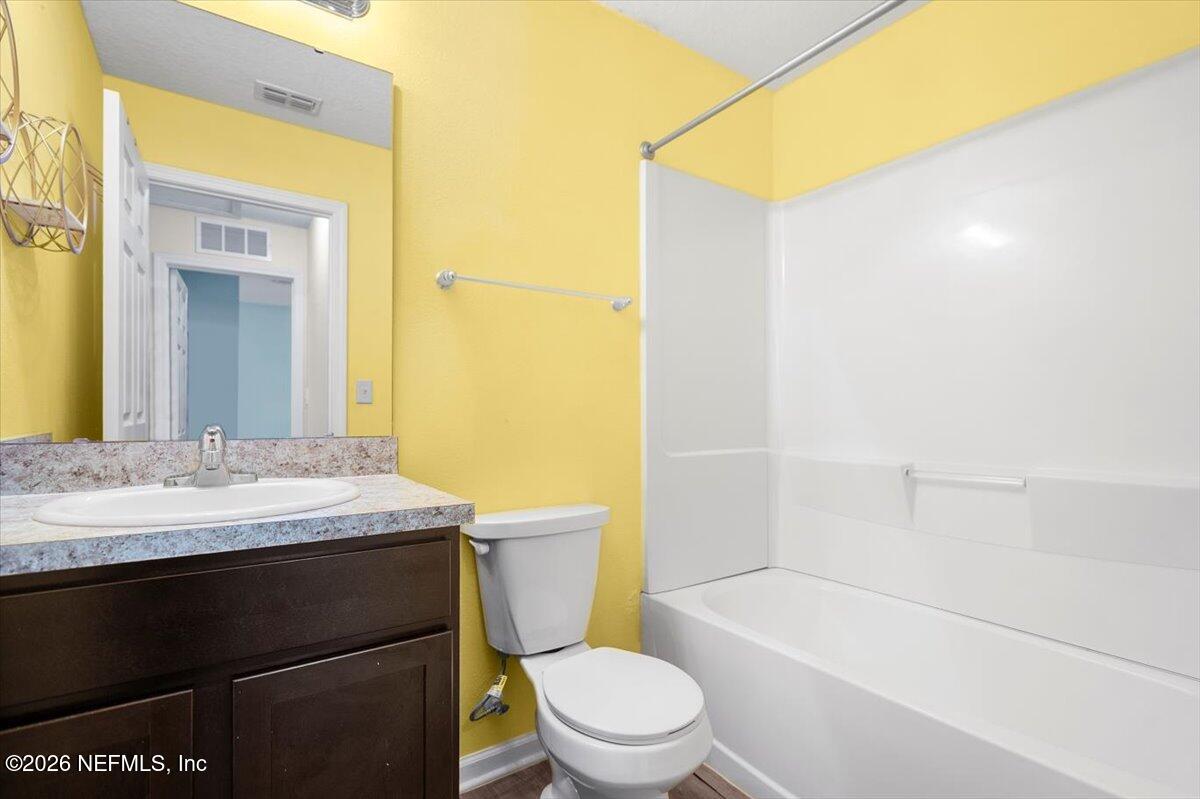 3094 Jennings Road Jacksonville, FL 32218 - Photo 14 of 33 a bathroom with a granite countertop sink toilet mirror and a bathtub