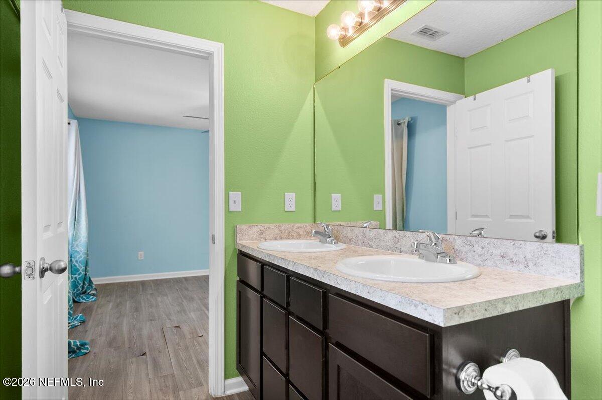 3094 Jennings Road Jacksonville, FL 32218 - Photo 23 of 33 a bathroom with a sink and a mirror