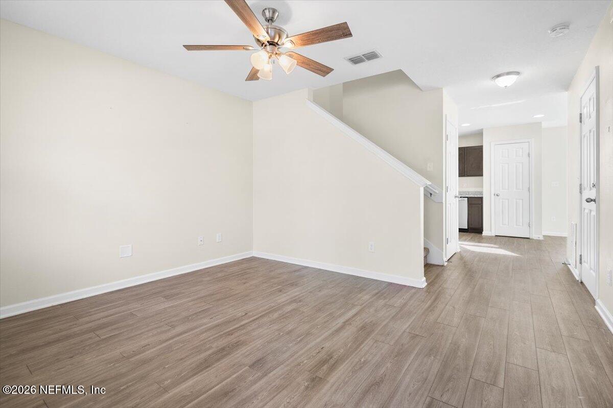 3094 Jennings Road Jacksonville, FL 32218 - Photo 4 of 33 a view of a big room with wooden floor ceiling fan and entryway