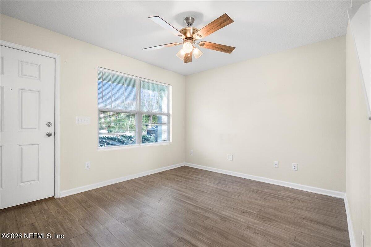 3094 Jennings Road Jacksonville, FL 32218 - Photo 5 of 33 an empty room with wooden floor and window